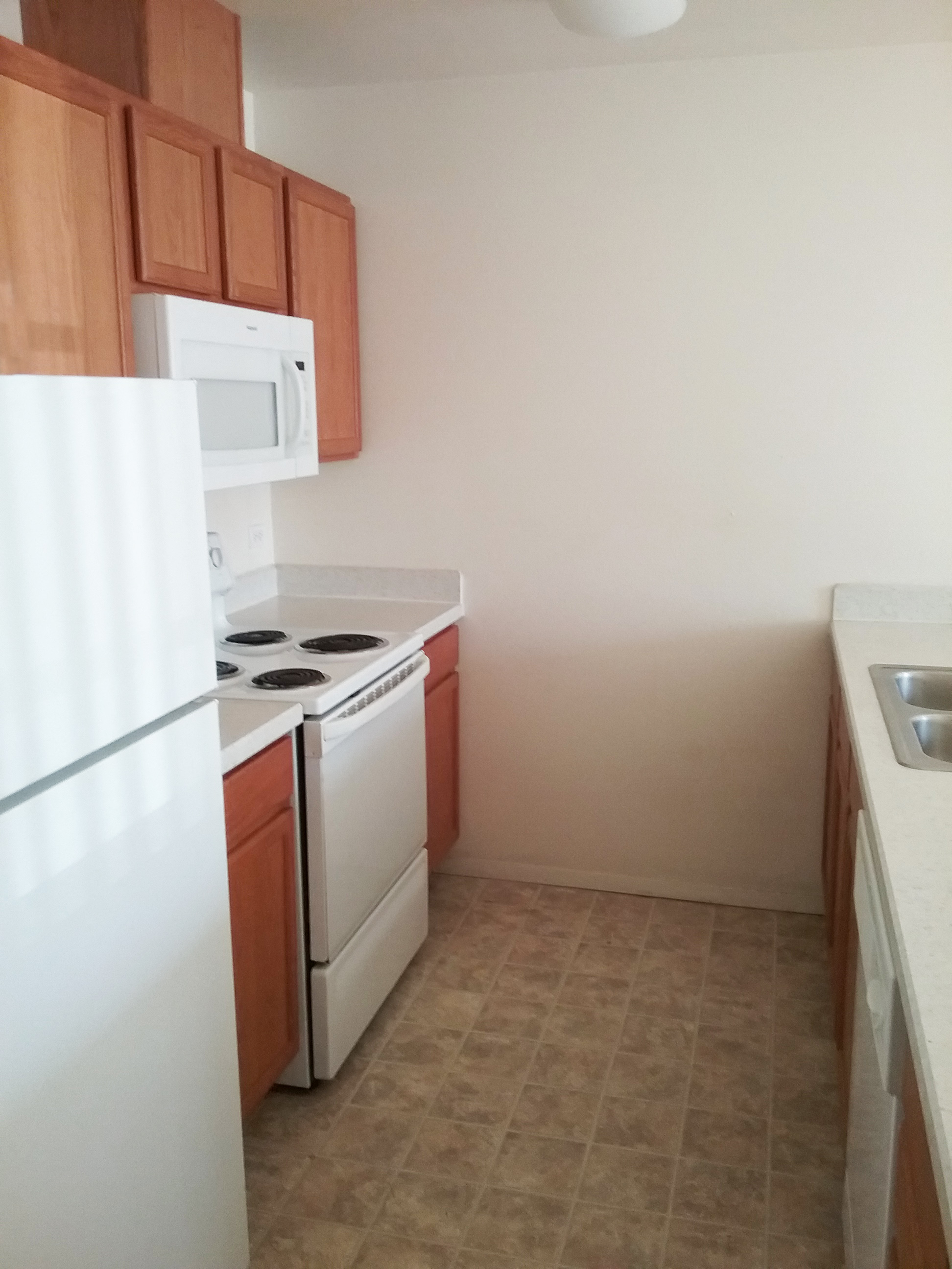 Image of refrigerator, stove, microwave, sink, cabinets, and dishwasher